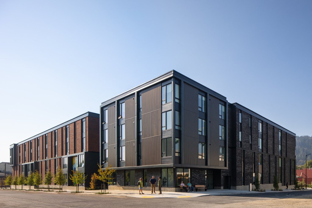 a large building with many windows and a street in front of it