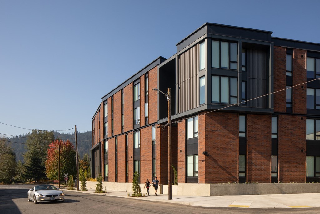 a brick building with a car parked in front of it
