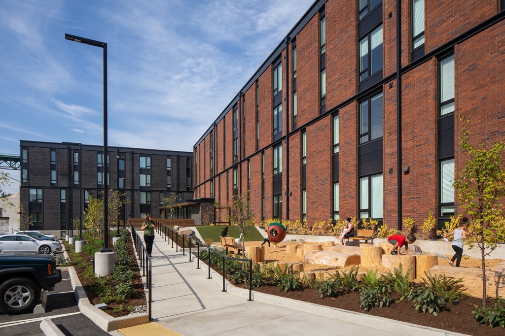 a large brick building with a playground in front of it