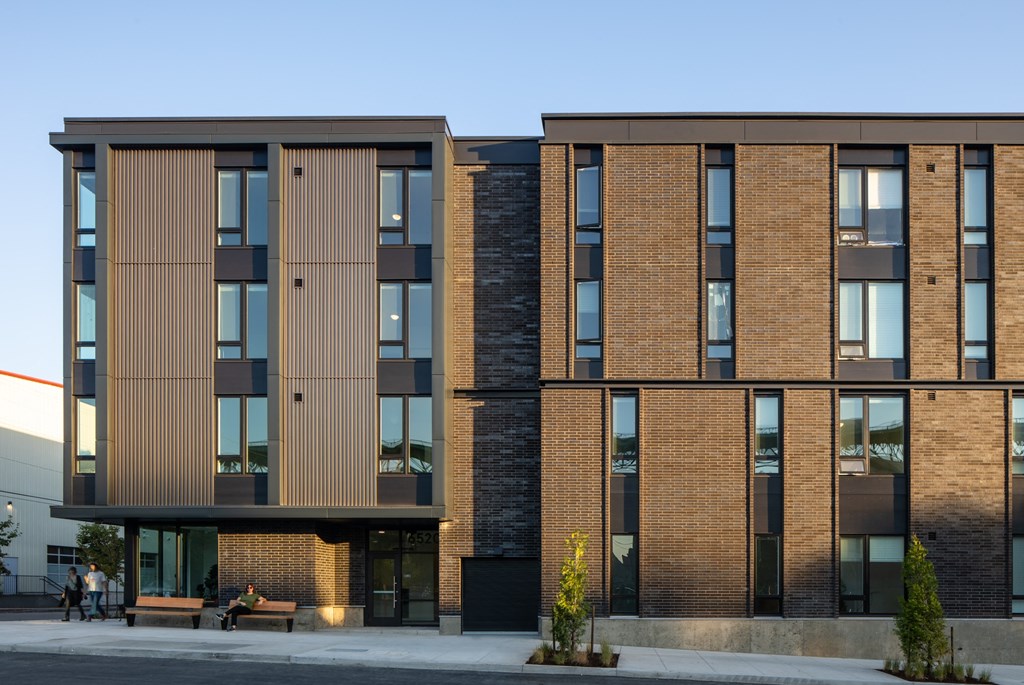 a rendering of a brick building with wood and glass windows