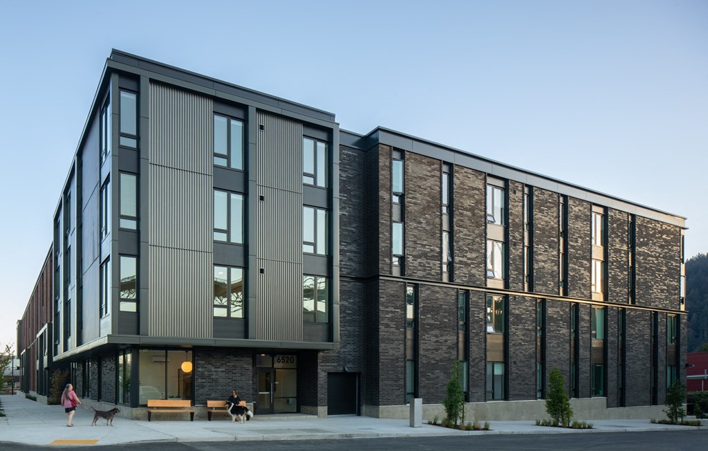a large building with a sidewalk in front of it