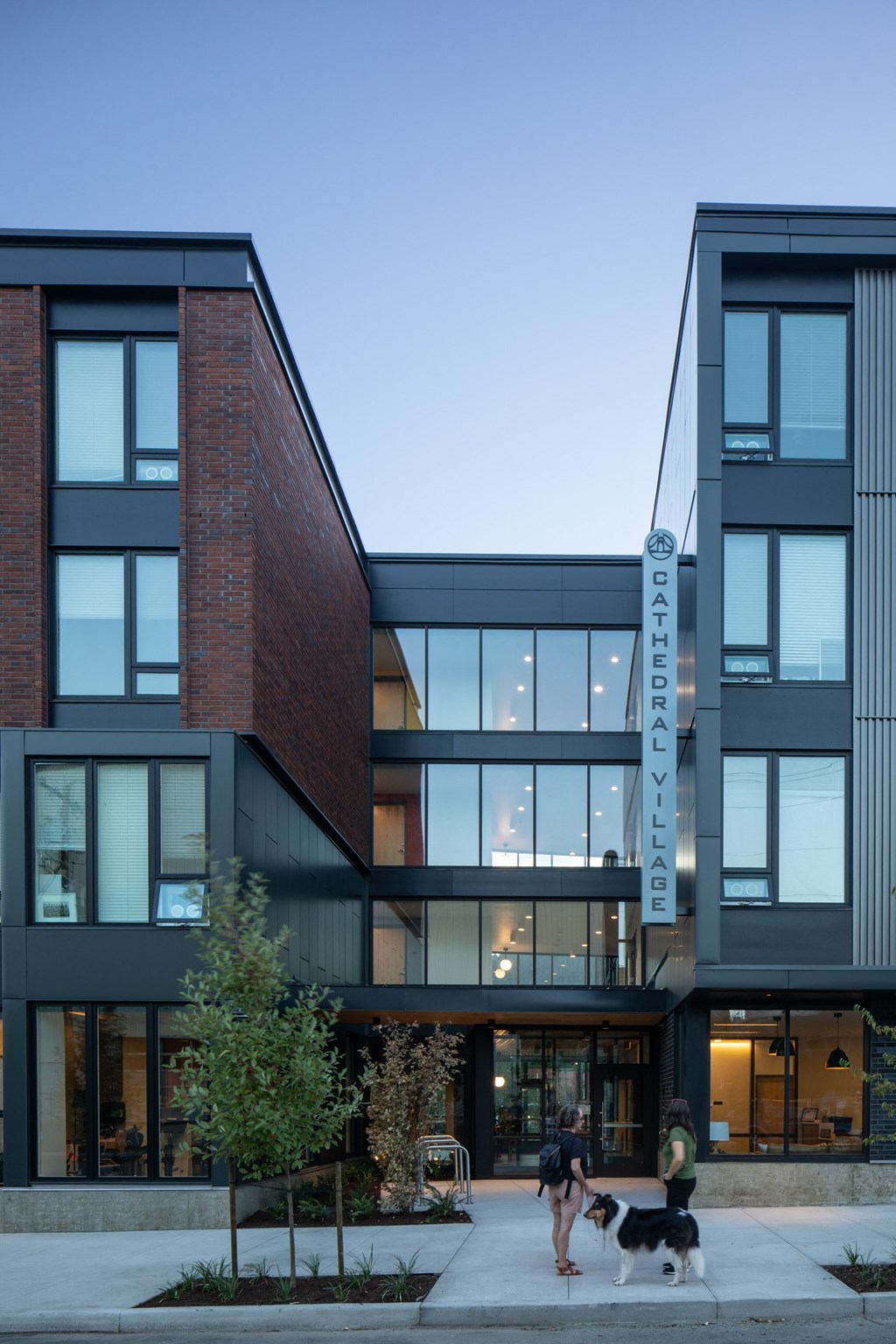 the exterior of a building with people walking a dog