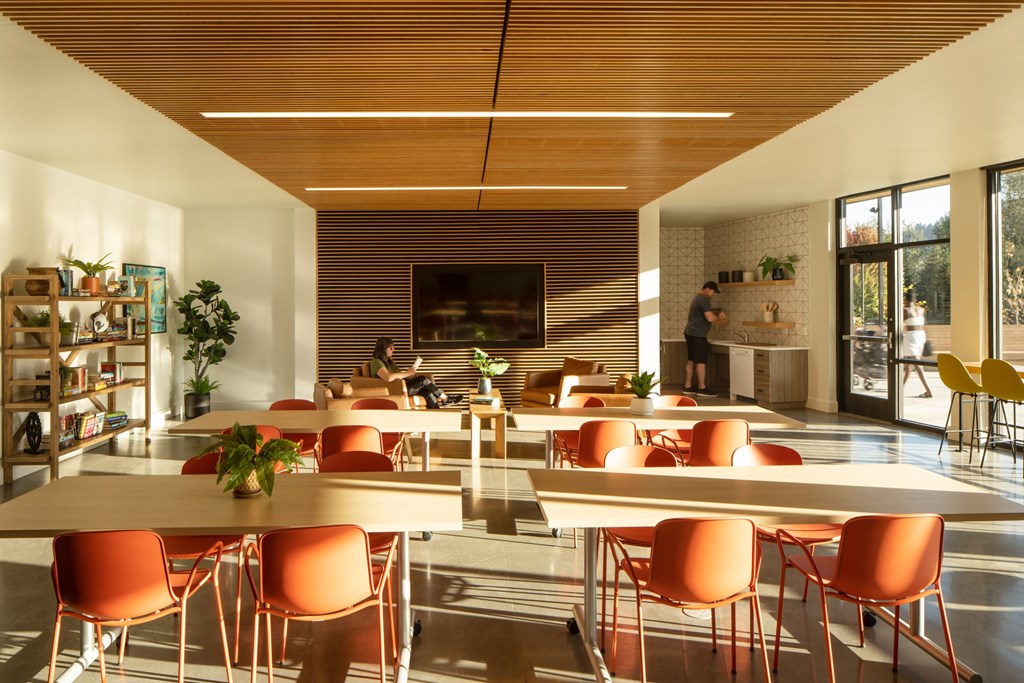 a large room with tables and chairs and a fireplace