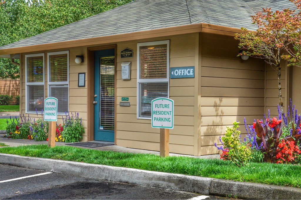 a small building with two signs in front of it