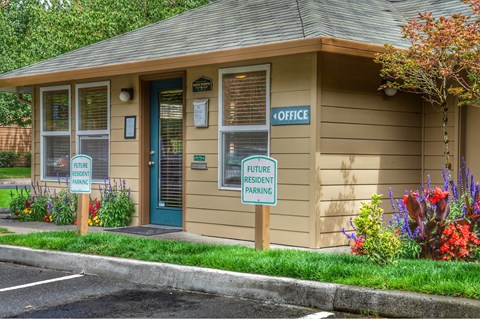 a small building with two signs in front of it