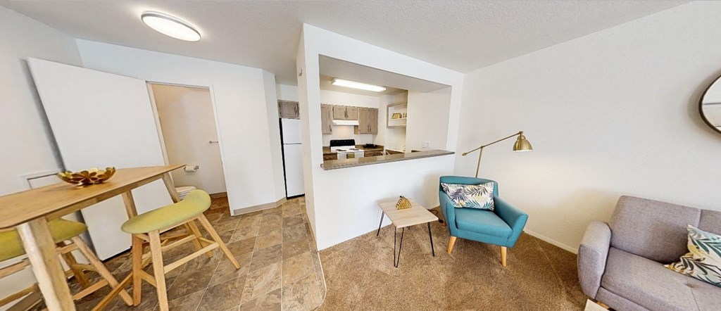 a living room with a dining area and a kitchen