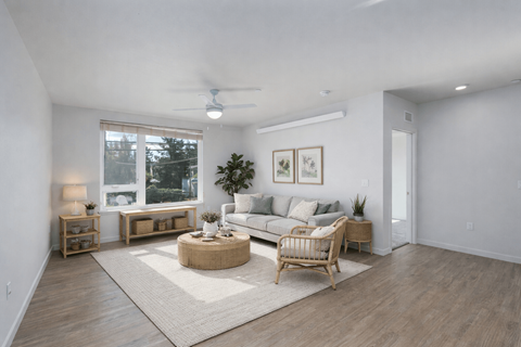 A living room with a couch, a chair, a table, and a rug.