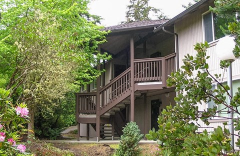 a house with a wooden deck on top of it