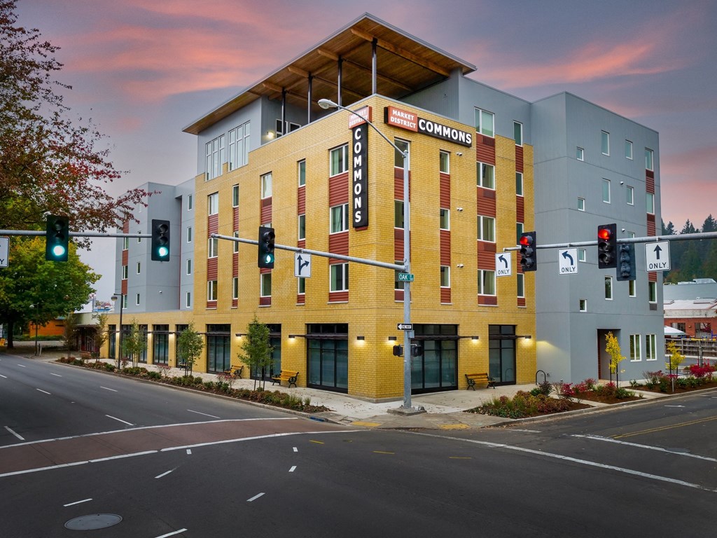 a building with a sign on the corner of a street