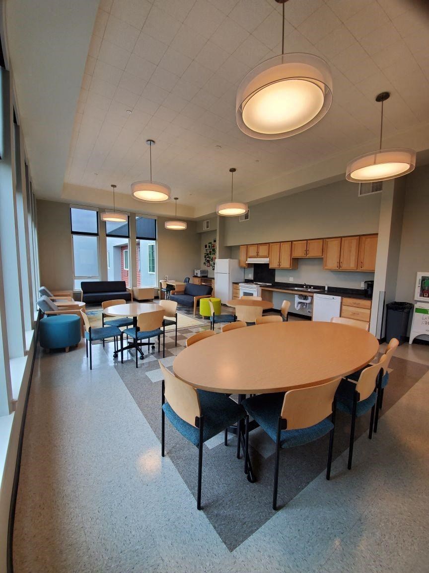 a large room with a table and chairs