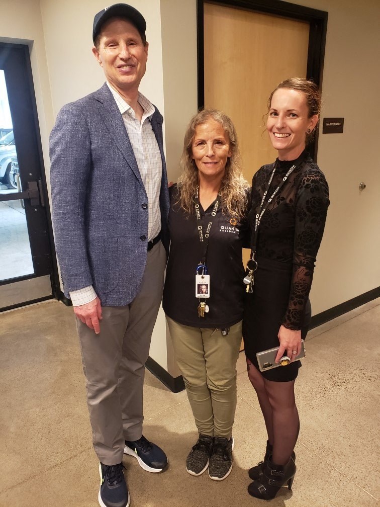 two women and a man posing for a picture