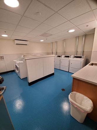 an empty laundry room with washers and dryers