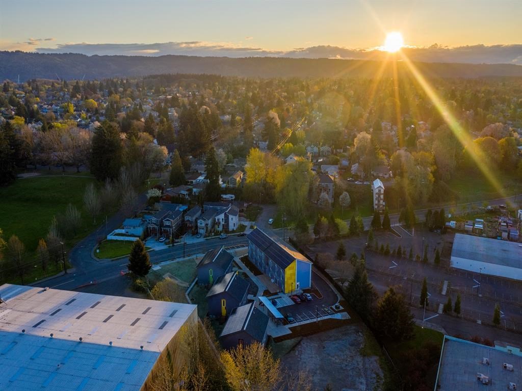 arial view of a city with the sun setting over the city