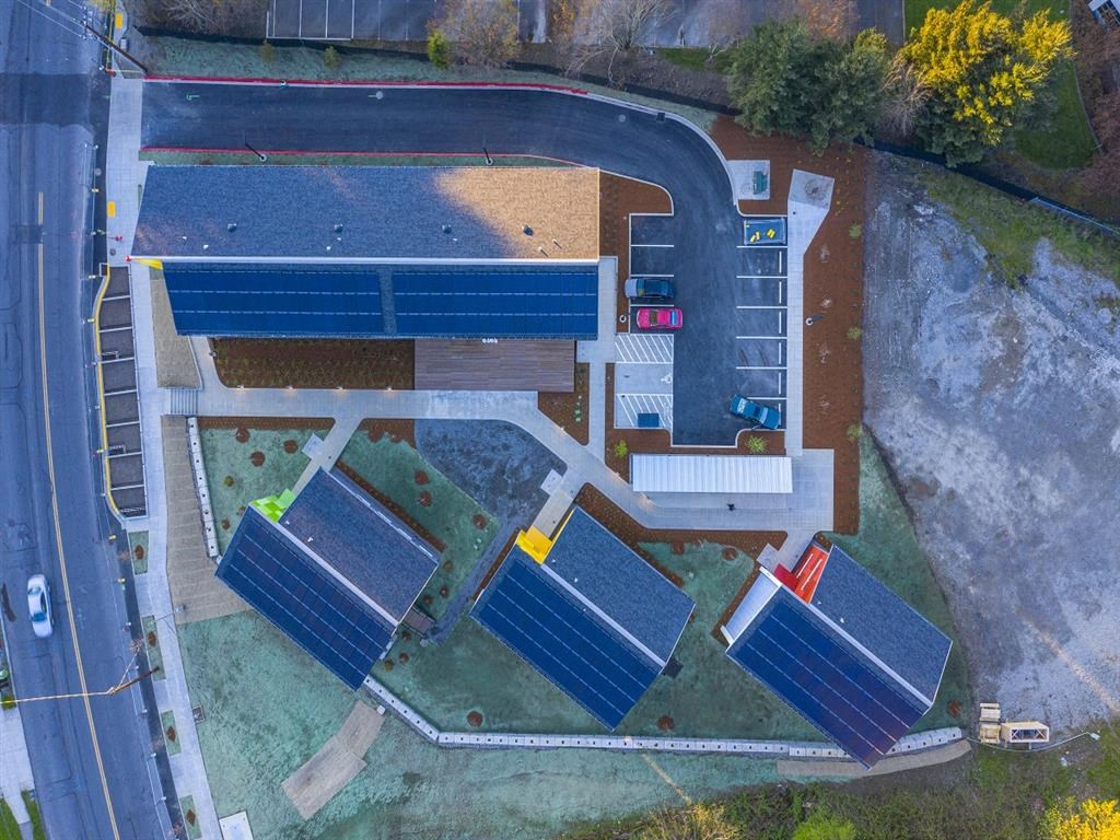 a bird s eye view of a school with solar panels on its roofs