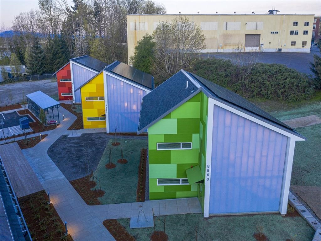 a group of colorful buildings in a parking lot