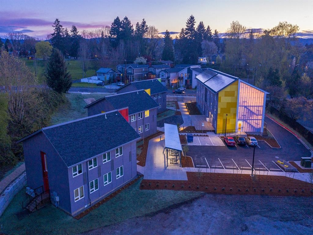 a aerial view of a house and a building lit up at night
