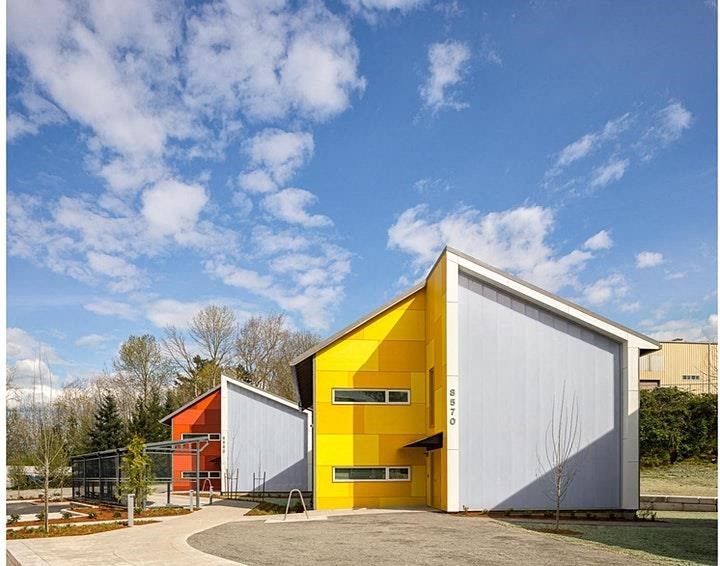 a yellow and white building with a blue sky