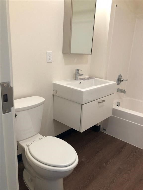 a bathroom with a toilet sink and a mirror