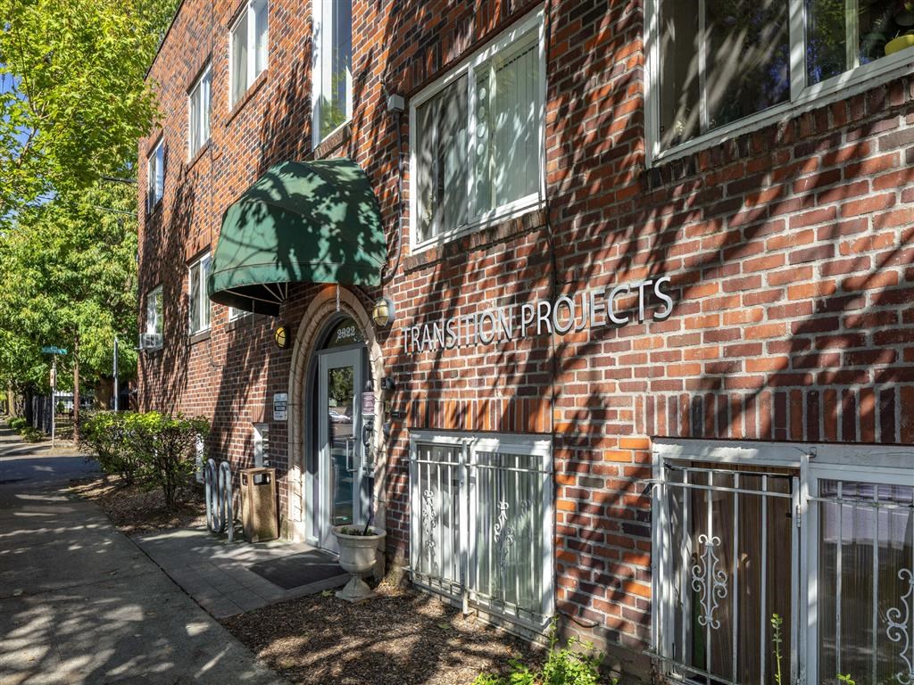 a brick building with a green awning on the side of it