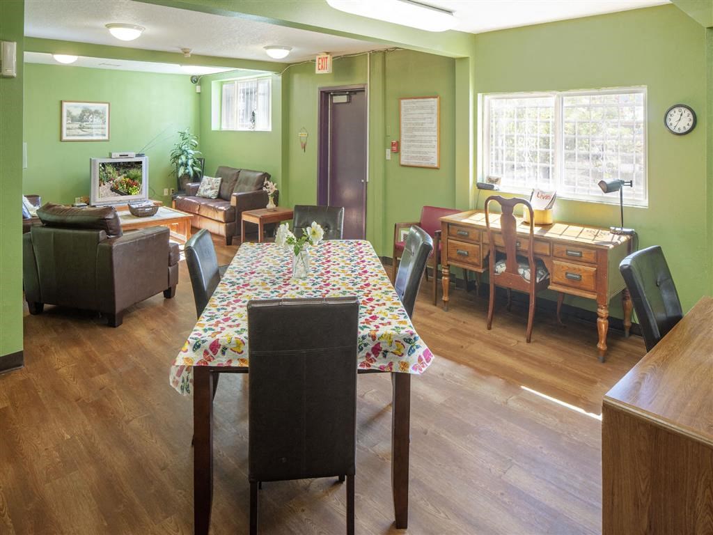 a dining room and living room with a table and chairs