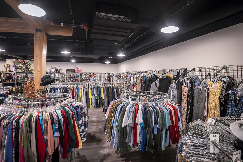 A clothing store with a variety of clothes on display.