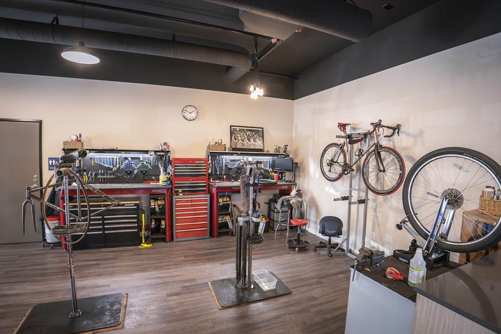 A bike shop with a variety of bikes and tools.
