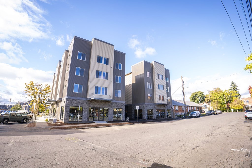 A street view of a row of modern apartment buildings.