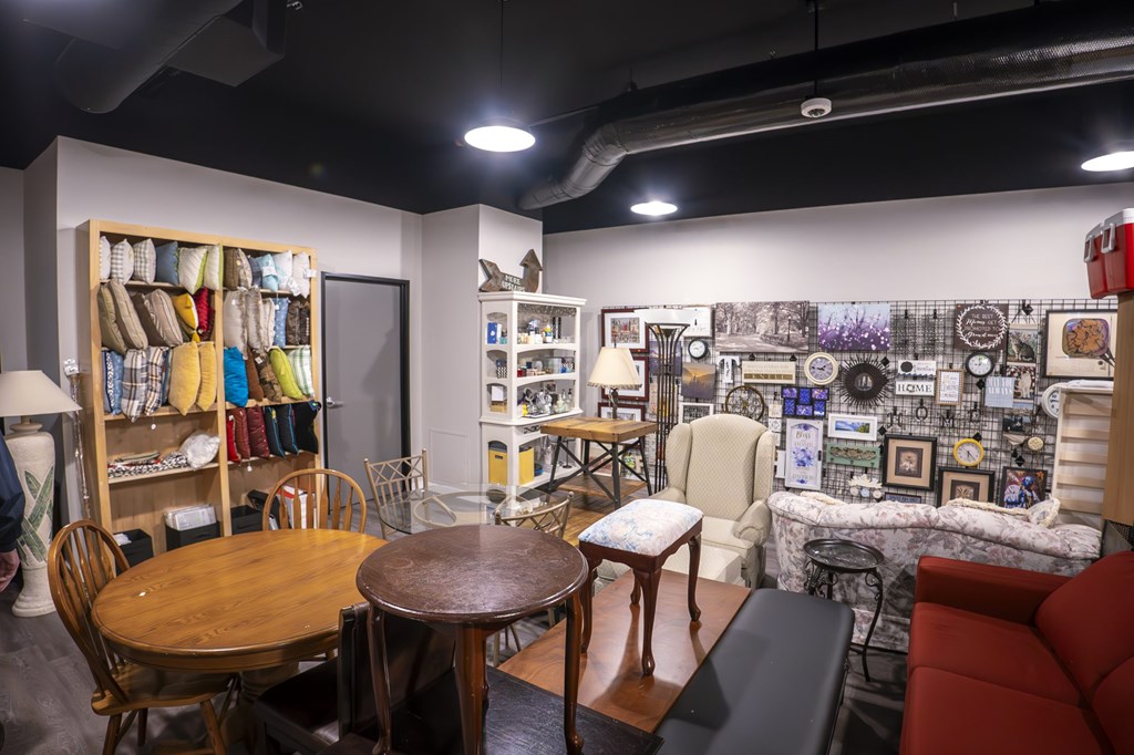 A room with a table, chairs, and a couch.