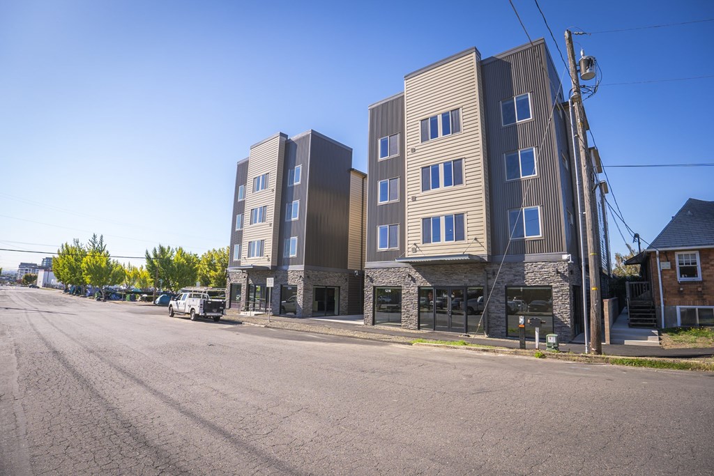 A street view of a residential area with apartment buildings.