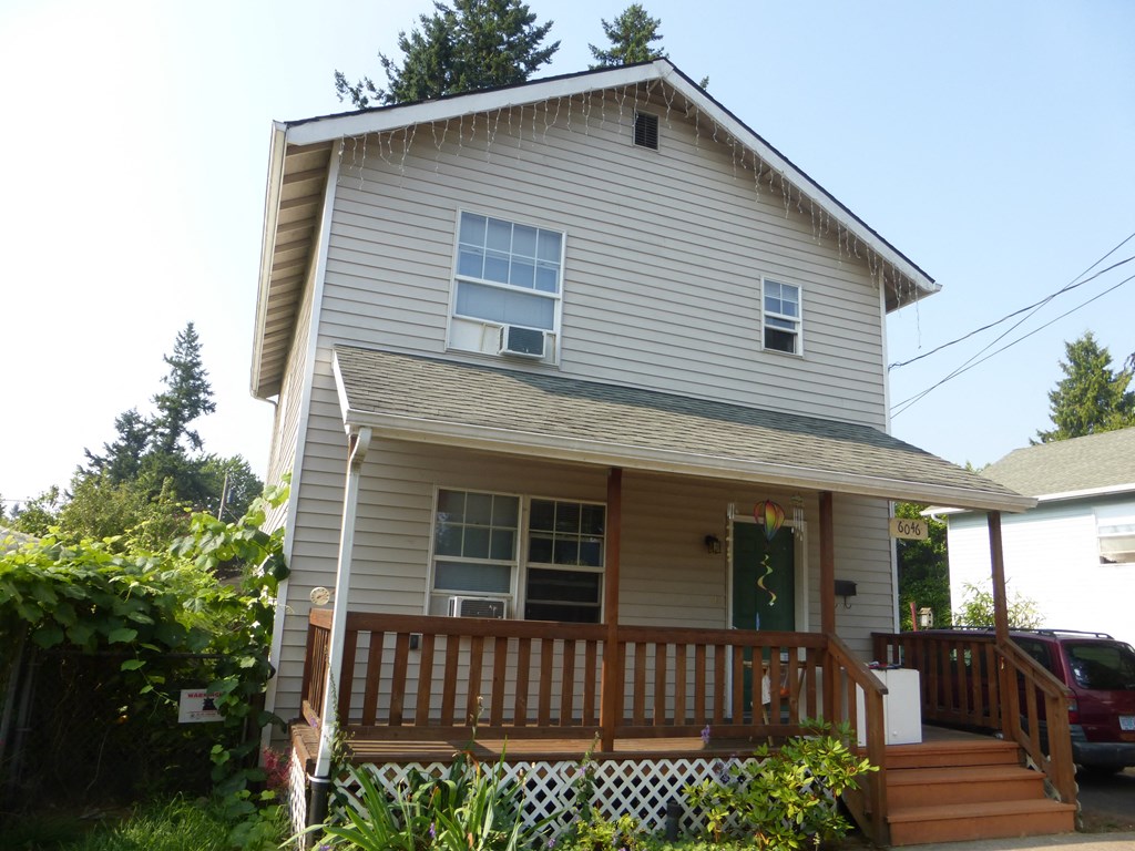 the front of the house with the deck