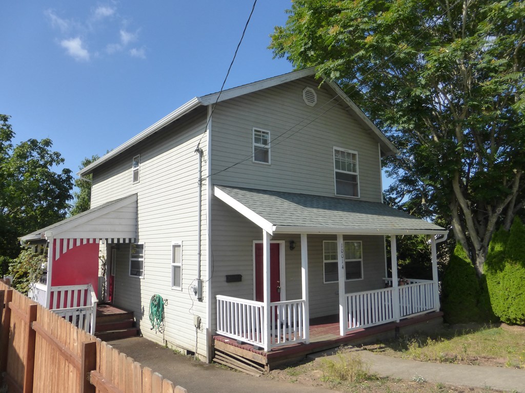 a house with a porch and a red door