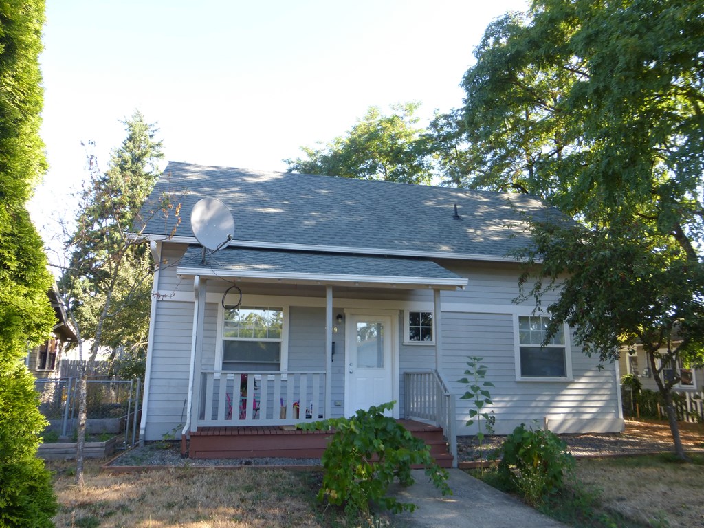 a white house with a satellite on the side of it