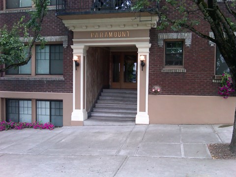 A brick building with a white entrance and the word Paramount above it.