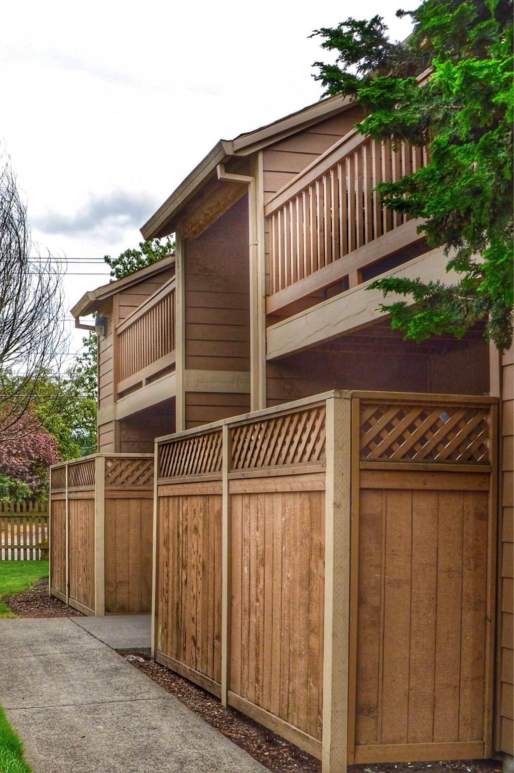 a wooden fence in front of a house with a deck