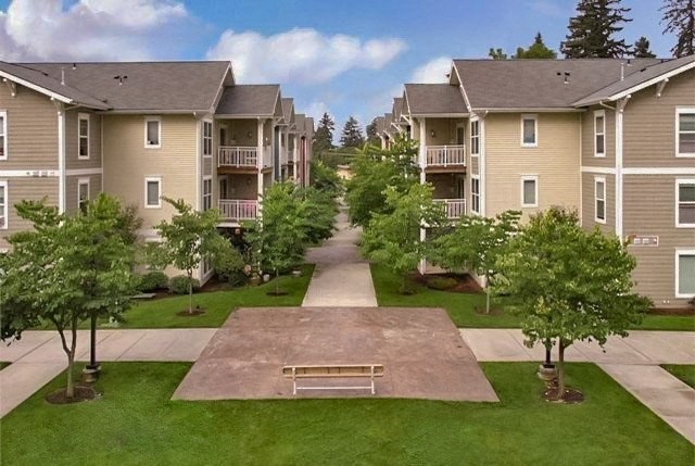an aerial view of an apartment complex with trees