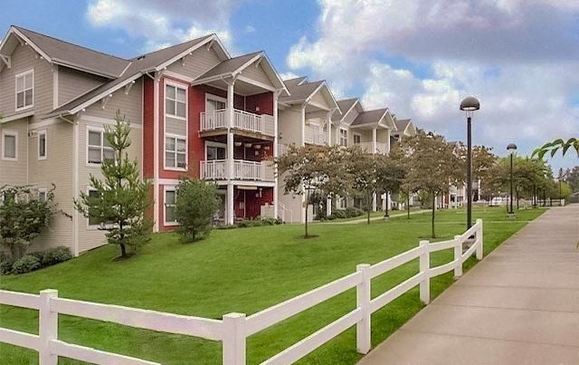 a row of houses next to a sidewalk