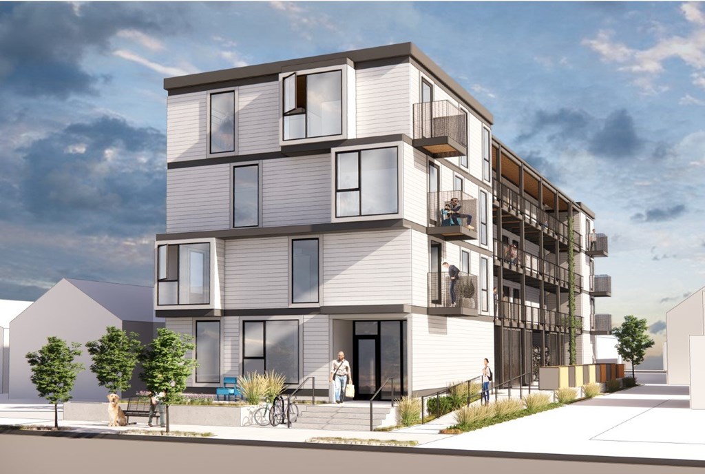 A modern apartment building with balconies and multiple stories.