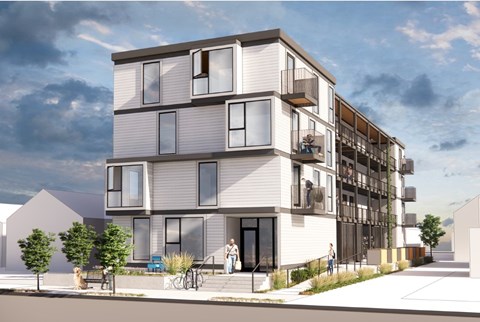 A modern apartment building with balconies and multiple stories.
