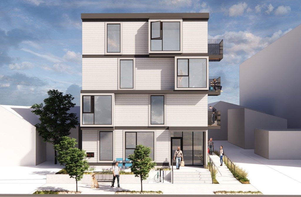 A modern residential building with people walking in front.