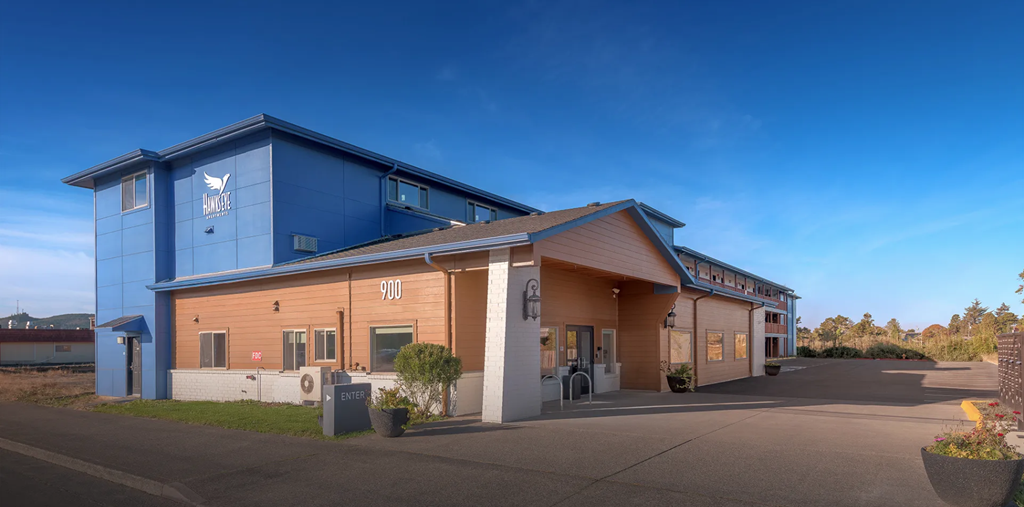 A blue and orange building with a white sign on the front.