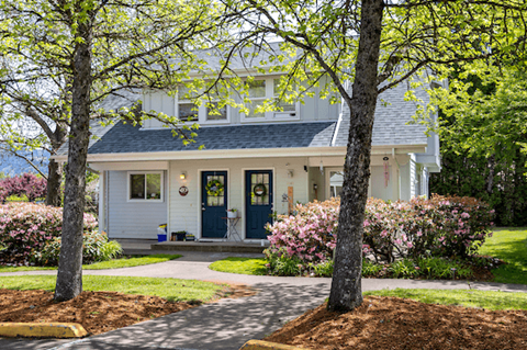 A white house with a blue door and windows.