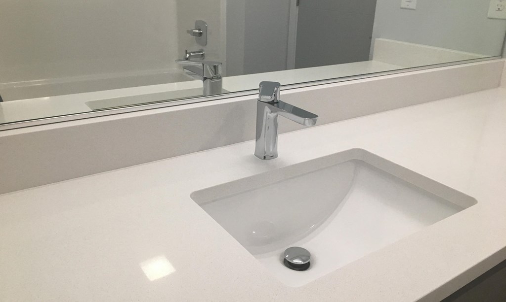a sink in a bathroom with a mirror above it
