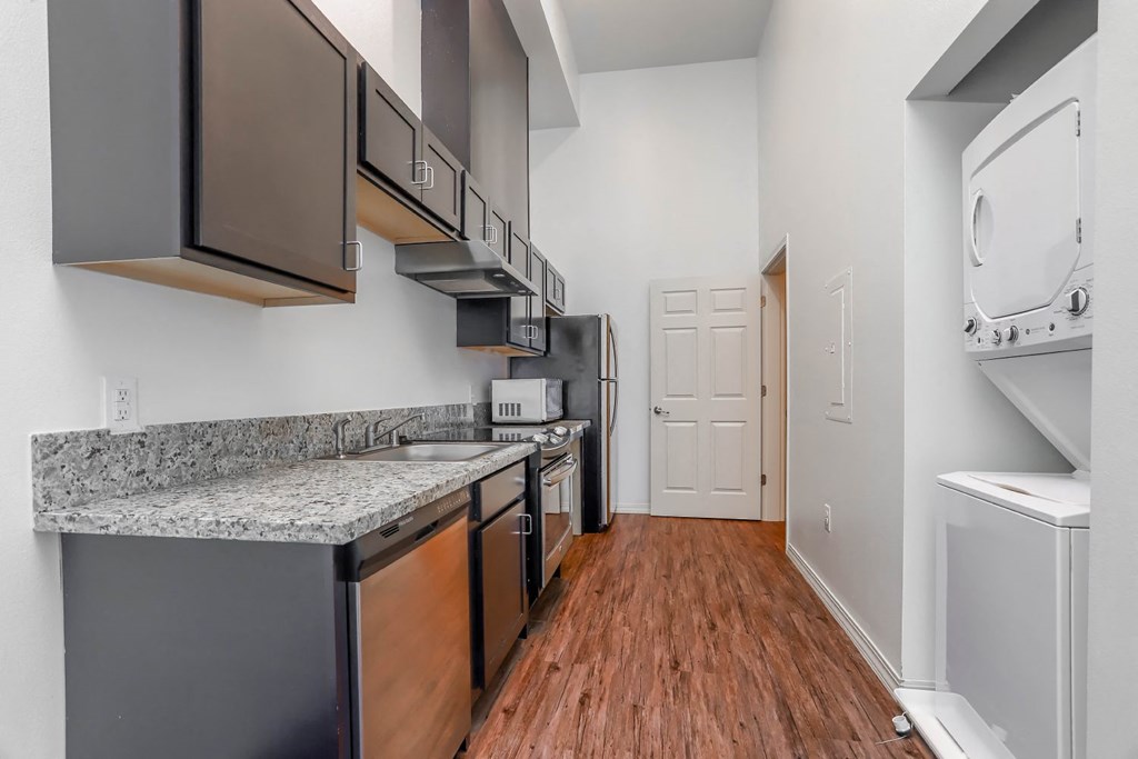 a kitchen with stainless steel appliances and granite countertops