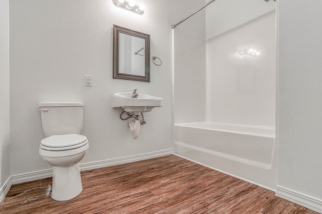 a bathroom with a toilet sink and bathtub