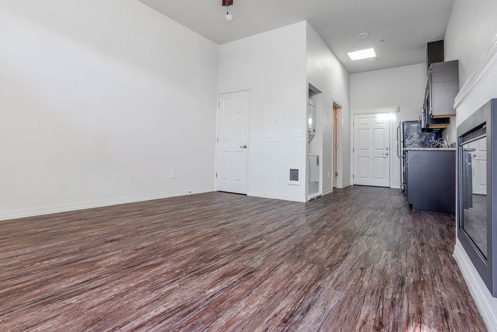 a bedroom with a medium sized bed and a kitchen with a stove and refrigerator