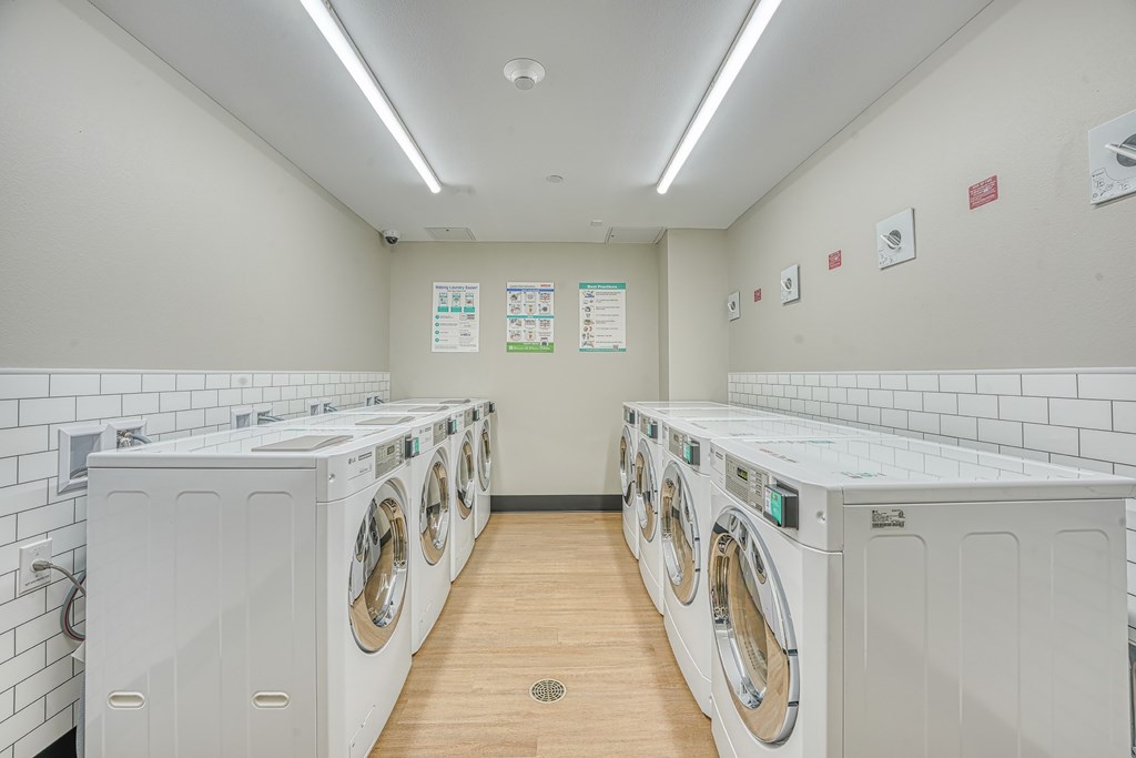 A row of washing machines in a laundromat.