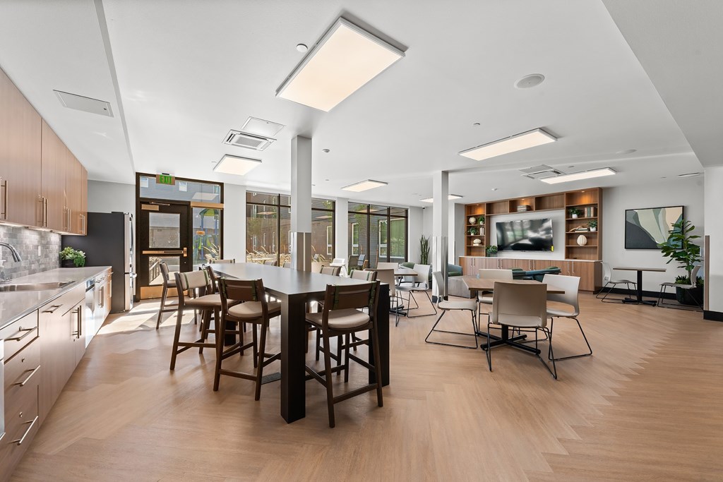 A modern kitchen with a dining table and chairs.