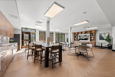A modern kitchen with a dining table and chairs.