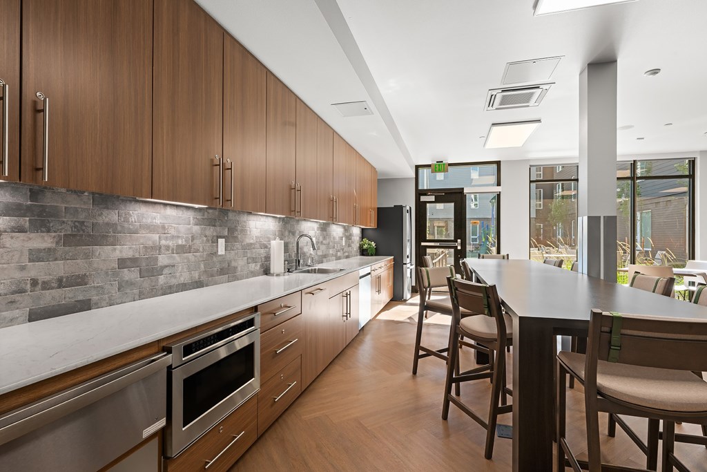 A modern kitchen with wooden cabinets and stainless steel appliances.