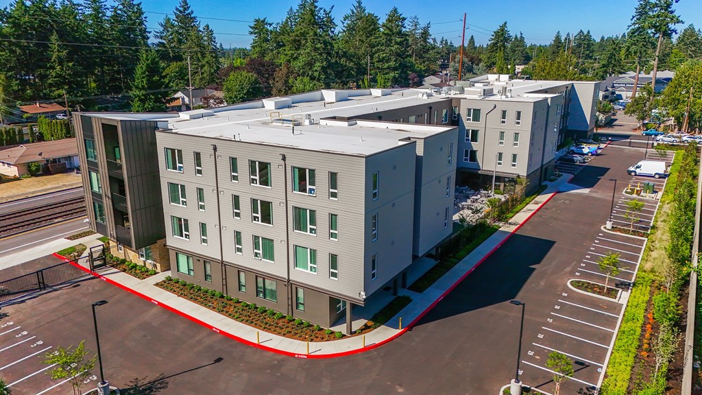 A large building with a parking lot in front of it.